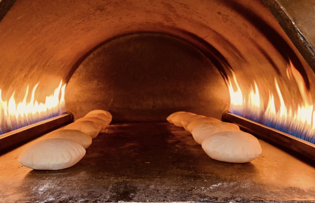 Fresh Lebanese bread rising in our oven